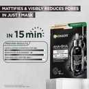 Garnier AHA+BHA Charcoal Icharbon Matifying Mattiant Serum Mask in a black resealable pouch, shown on a light gray background with promotional text highlighting pore-mattifying results in 15 minutes.