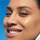 Garnier BB Cream All In One Perfector Anti-Age Medium SPF 15  - Close-up of a woman's face with a bright blue sky background