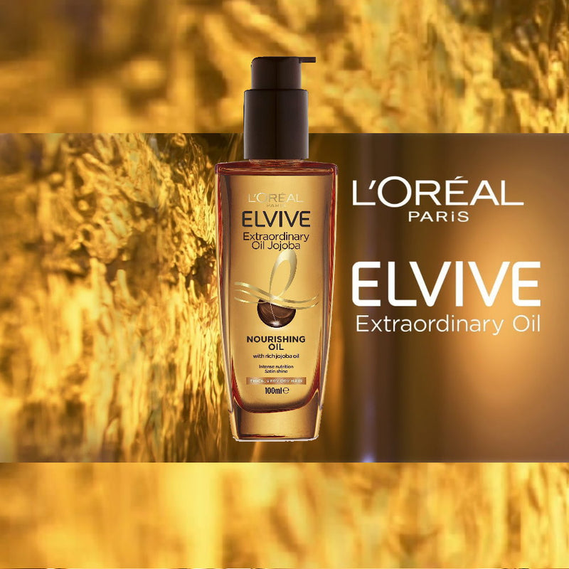 L'Oreal Elvive Extraordinary Oil bottle with a blurred natural background