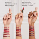 Three hands holding lipsticks with color swatches on a white background