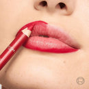Close-up of a red lip crayon being applied to lips, with the brand name L'Oréal Paris visible on the pencil. L'Oreal Paris Color Riche Couture Lip Liner 2010 La Prune