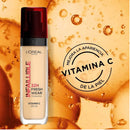 L'Oreal Infallible foundation bottle with vitamin C on an orange background