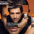 L'Oreal Men Expert skincare product with a man holding it against an orange background