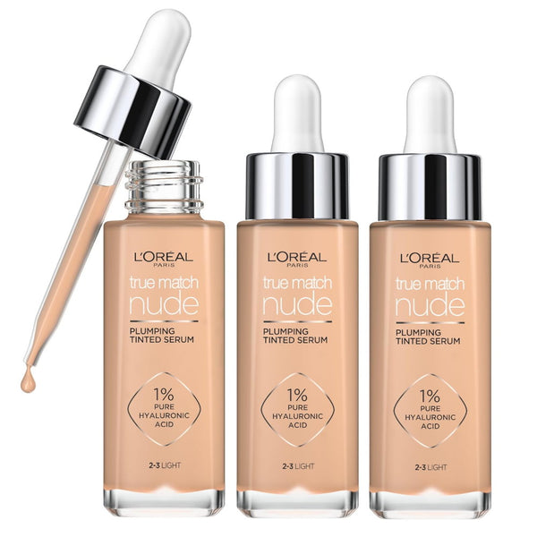 Four bottles of L'Oreal Paris True Match Nude Plumping Tinted Serum with applicators, showcasing the serum in a neutral shade.