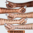 Multiple hands holding makeup products with color swatches on a white background, indicating 49 shades.