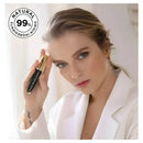 Woman holding a cosmetic product with a 'Natural 99%' label in the corner.