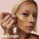 Person applying makeup with a brush, focusing on facial features, on a pink background - Makeup Warehouse Australia 
