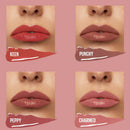 Four lip color swatches shown on a pink background, each with a close-up of lips wearing the shade and a lipstick smear below labeled KEEN, PUNCHY, PEPPY, and CHARMED.