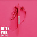 A pink makeup pencil labeled 'DUNTS OUTLA' stands upright on a bright pink background with a textured heart shape made from matching pink powder. Large white text in the lower left reads 'ULTRA PINK (MATTE)'.