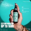 Hand holding a NYX Professional Makeup Dewy Finish Fini Satine spray bottle against a teal background