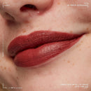 NYX Smooth Whip Matte Lip Cream Latte Foam Close-up of a person's lips wearing a red lipstick with NYX branding.