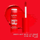 NYX Professional Makeup Smooth Whip Matte Lip Cream in Icing on Top 12, shown with the red tube and applicator wand against a bright red background with a matching red lip smear. NYX Smooth Whip Matte Lip Cream 12 Icing on Top 