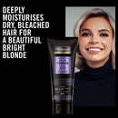 TRESemmé coconut oil purple toning mask with a model's face on a black background